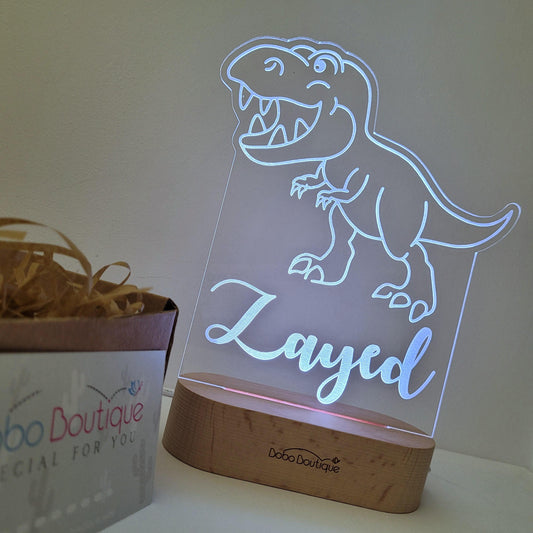 Charming dinosaur night lamp, showcasing a lifelike and playful dinosaur design. This adorable dinosaur-themed lamp adds a touch of whimsy to any child's bedroom, providing a delightful and comforting source of light for nighttime adventures | Bobo Boutique UAE Giftshop